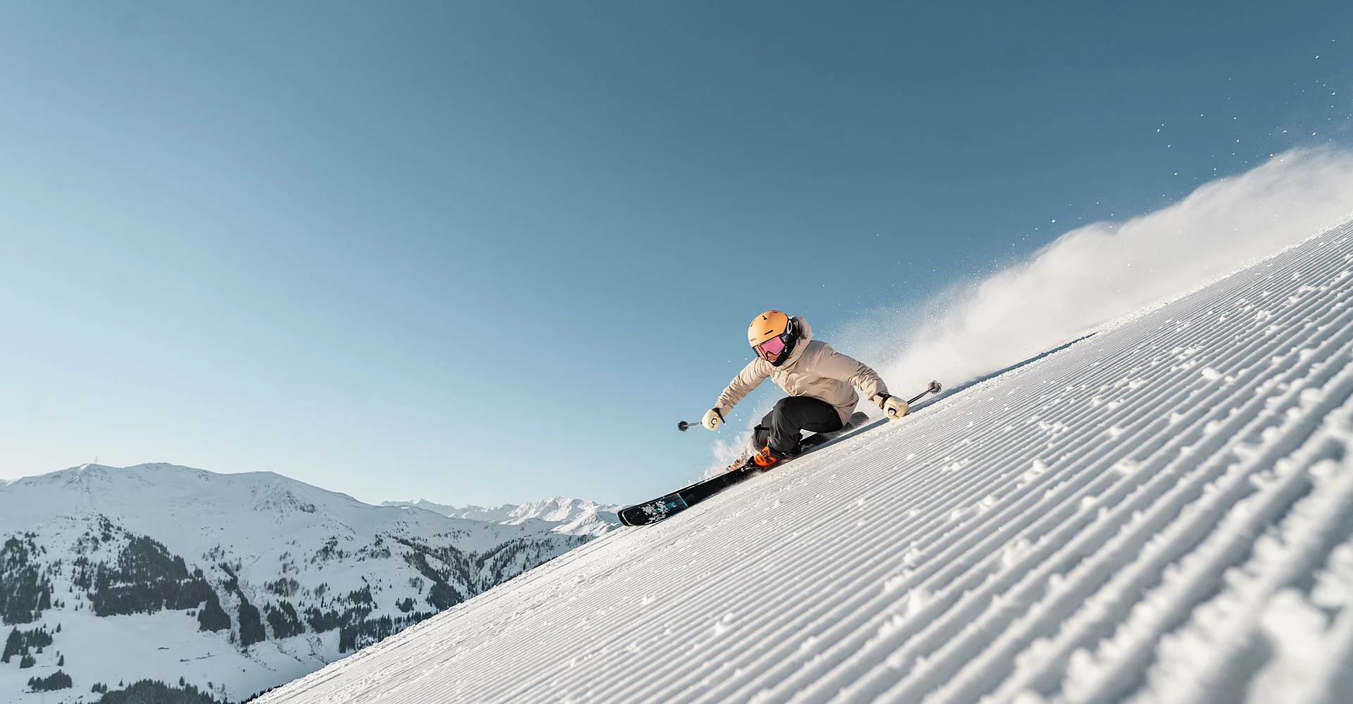 A skier on a freshly groomed piste