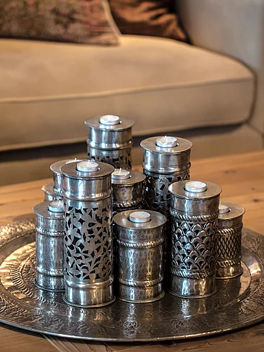 Exclusive inclusive Elegant candle holders on a wooden table in the Schmiedalm - the chalet in Saalbach Hinterglemm