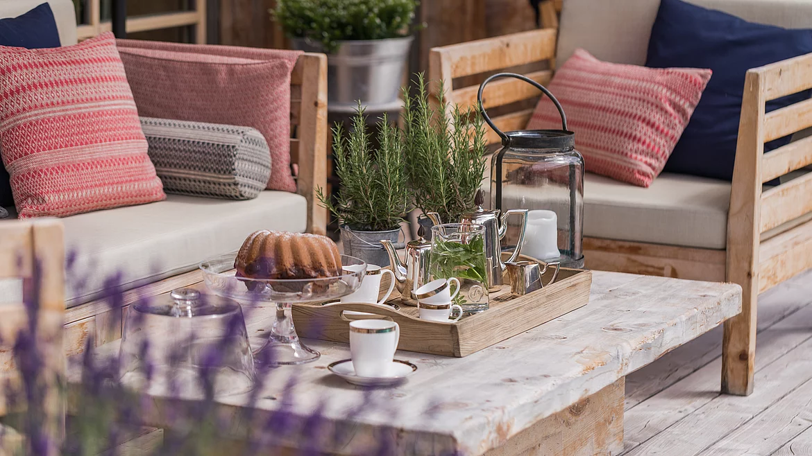 Cosy seating on the terrace at the Schmiedalm