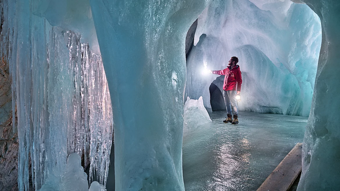 A man stands in a cave in the Eisriesenwelt in Salzburg