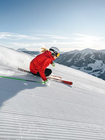 Ski-in & Ski-out A skier on a freshly groomed piste